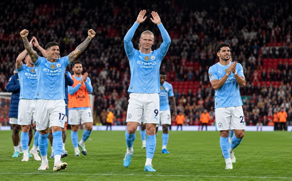 Manchester City players applaud the travelling fans at Anfield after the 3-0 win over Liverpool